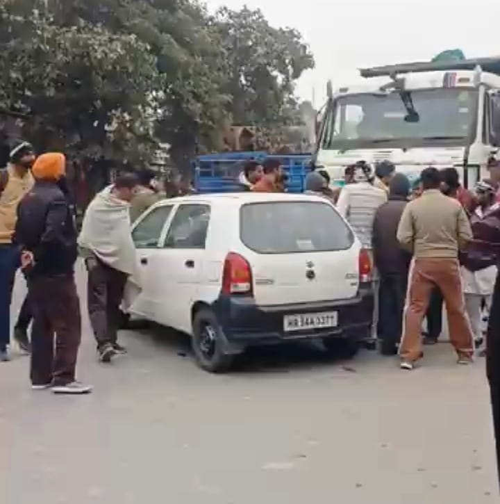 The dump truck dragged the car a considerable distance; the driver was injured
