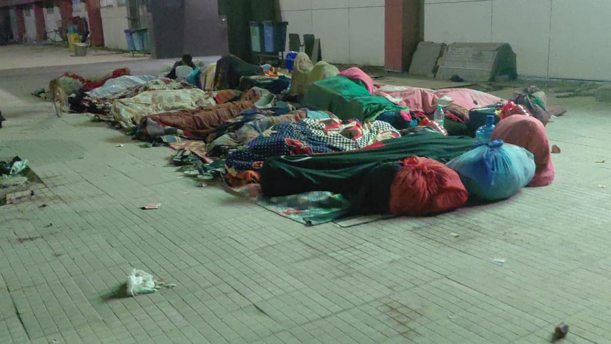 People are sleeping on the floor, and there are no signs indicating the location of night shelters