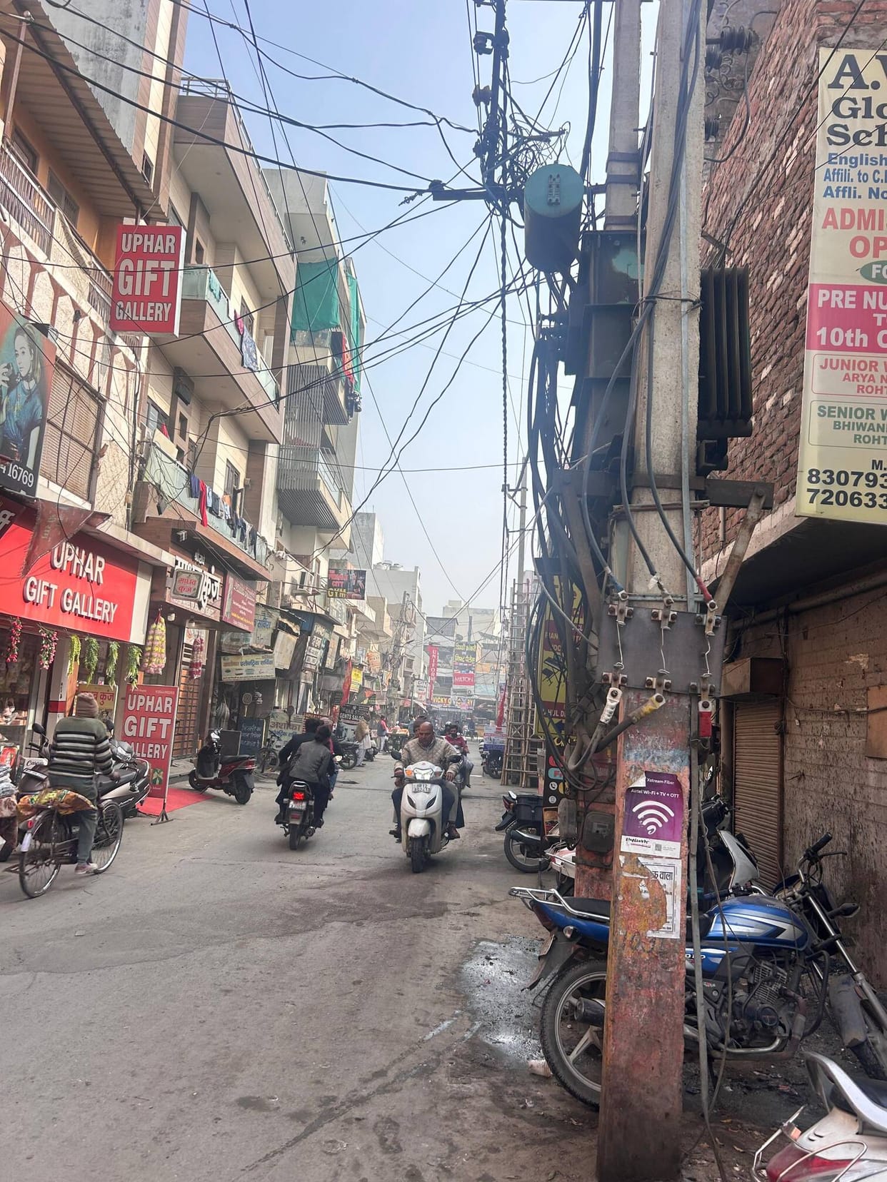 Transformers and hanging wires in the street pose a risk of accidents.