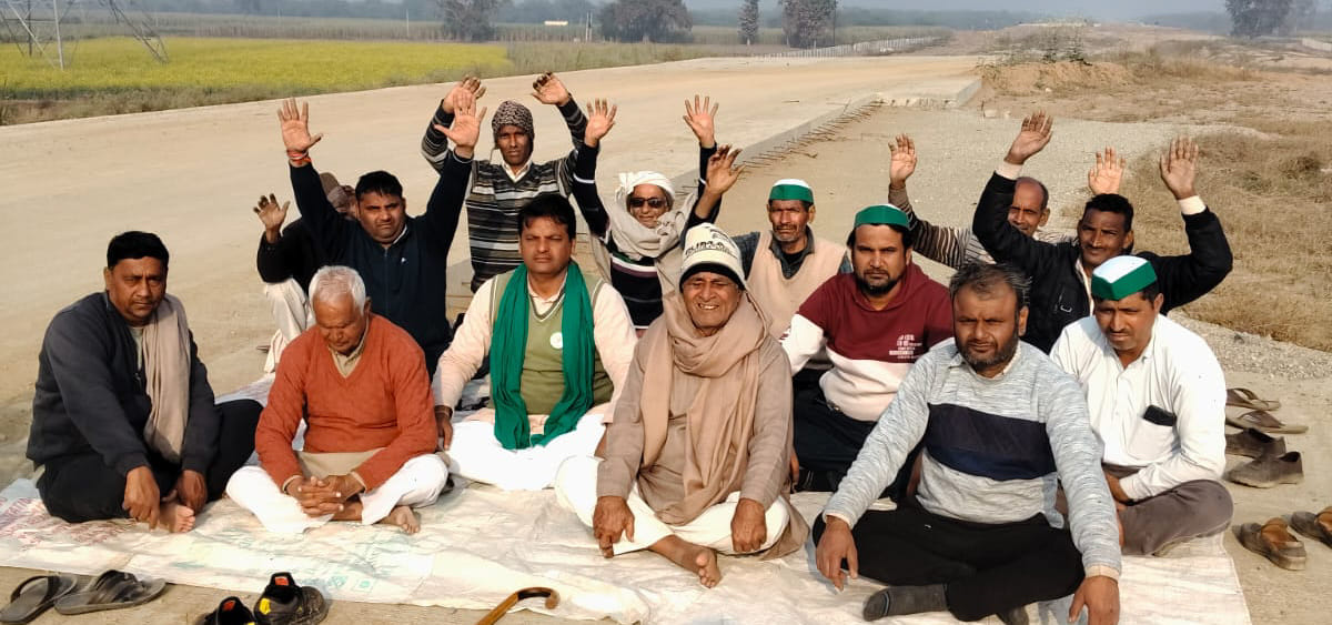 Illegal mining has left the service road in a ditch; farmers have stopped the DME construction work and started a sit-in protest.