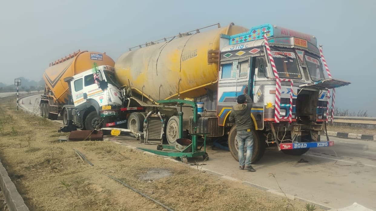 A second truck hit a stationary truck from behind, resulting in the death of a motor mechanic who was caught in the impact