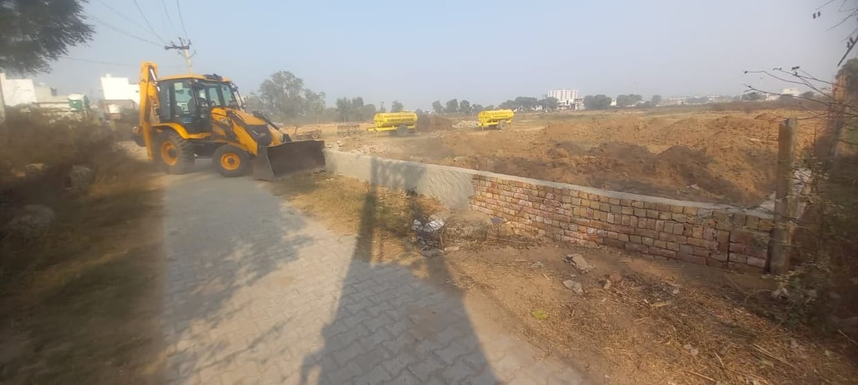 The bulldozer roared into action on the illegally developed colony.