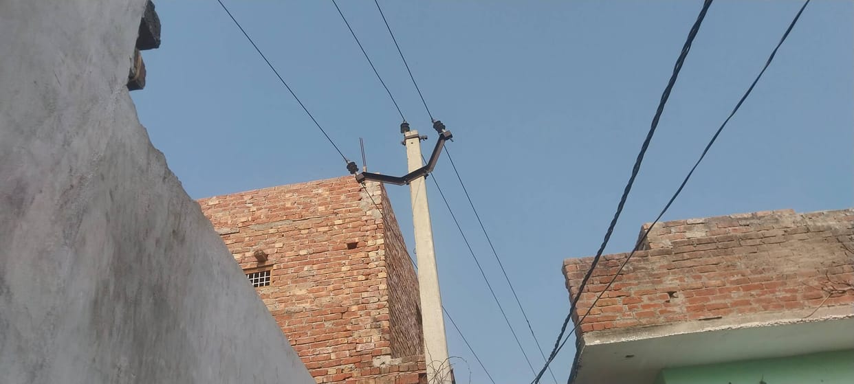 Danger of accident due to high tension line passing over houses