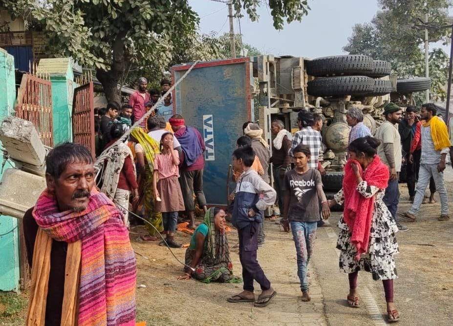 An out-of-control dump truck overturned after hitting a pole, killing a child who was playing nearby; locals blocked the road in protest