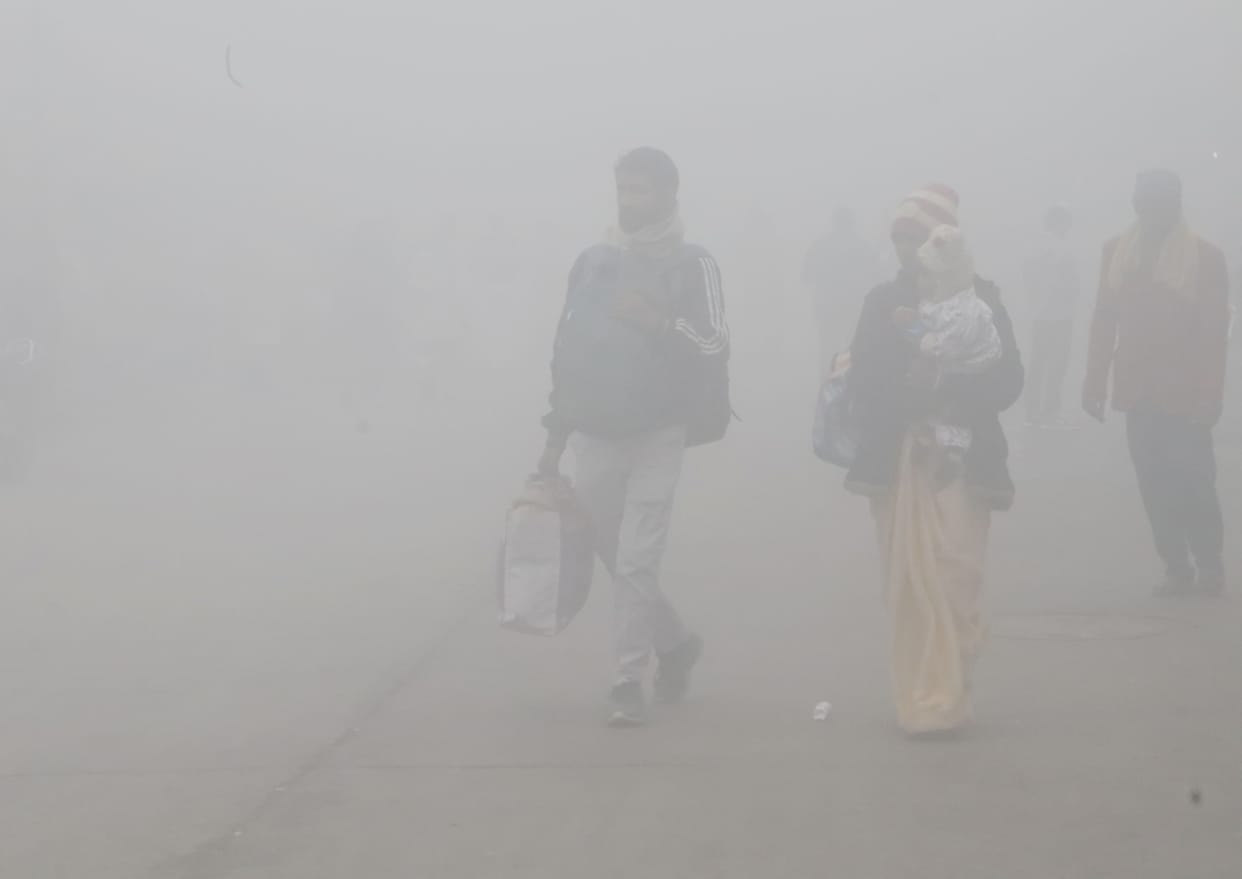 Vehicles crawled through dense fog...people suffered from the biting cold.