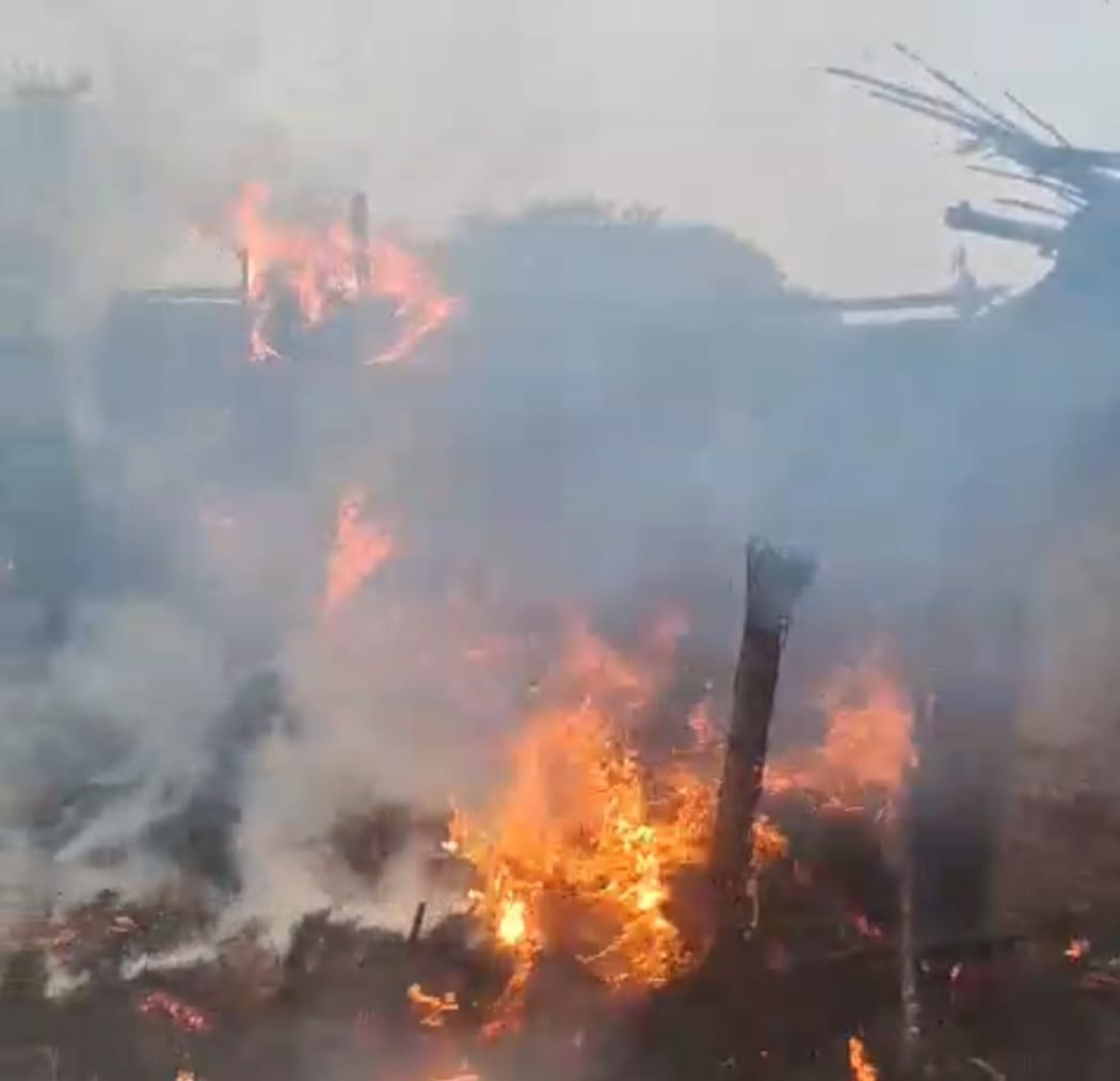 A spark from a bonfire set two brothers' homes on fire.