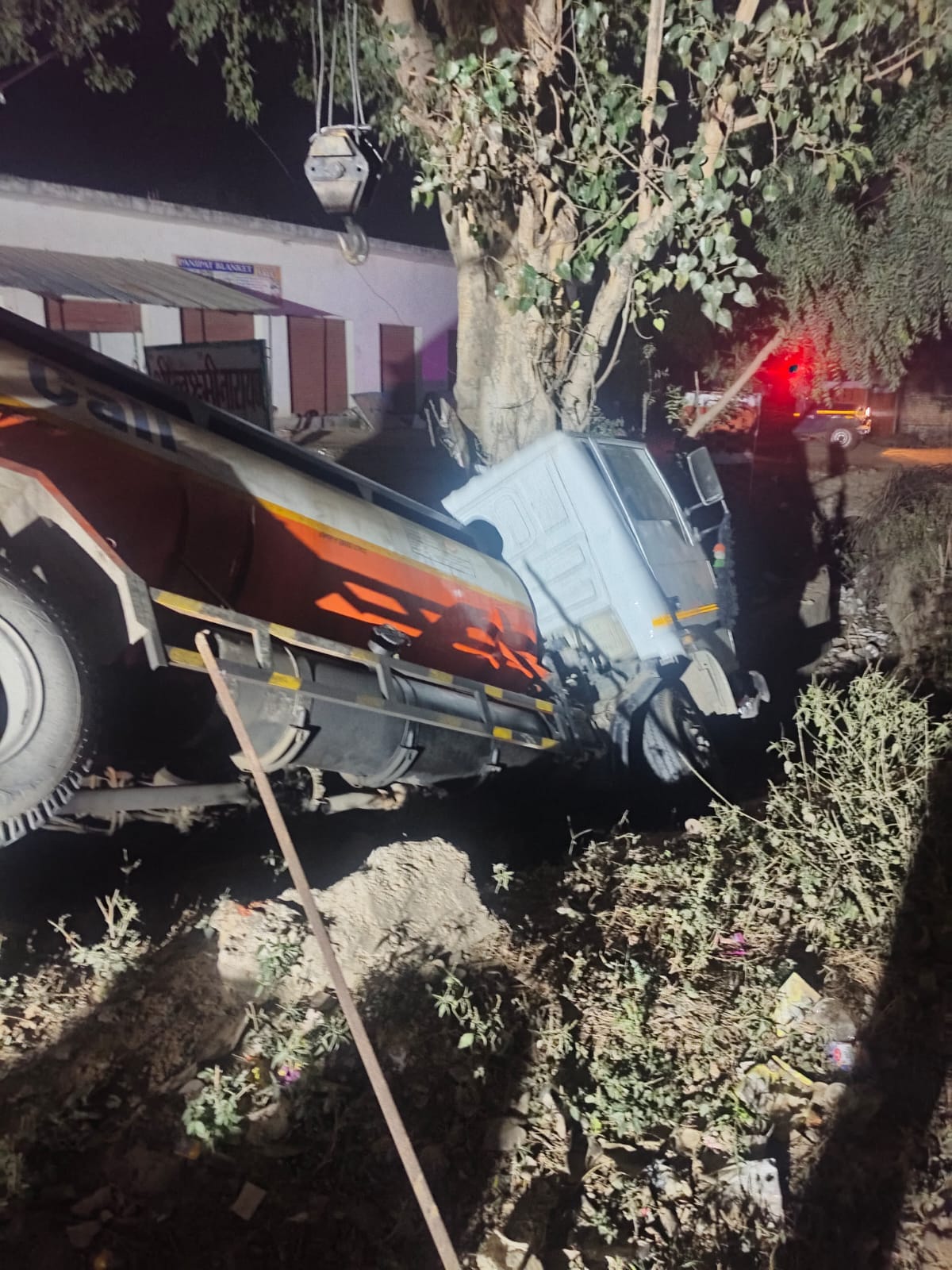 Uncontrolled tanker overturns on highway, driver trapped in cabin injured