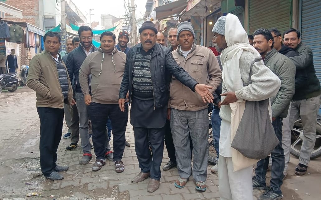 Shopkeepers, troubled by potholes on the road, staged a protest.