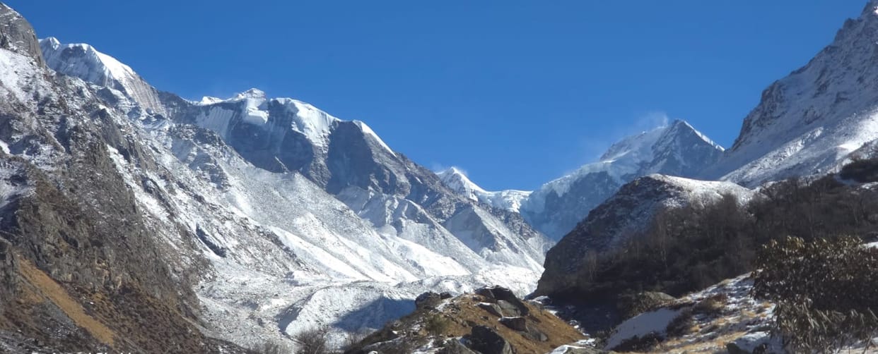 The high hills of Dronagiri village are covered with snow.