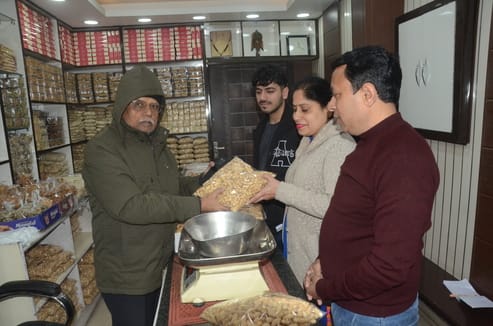 The market buzzes with the fragrant aroma of sesame, jaggery, peanuts and rewadi.