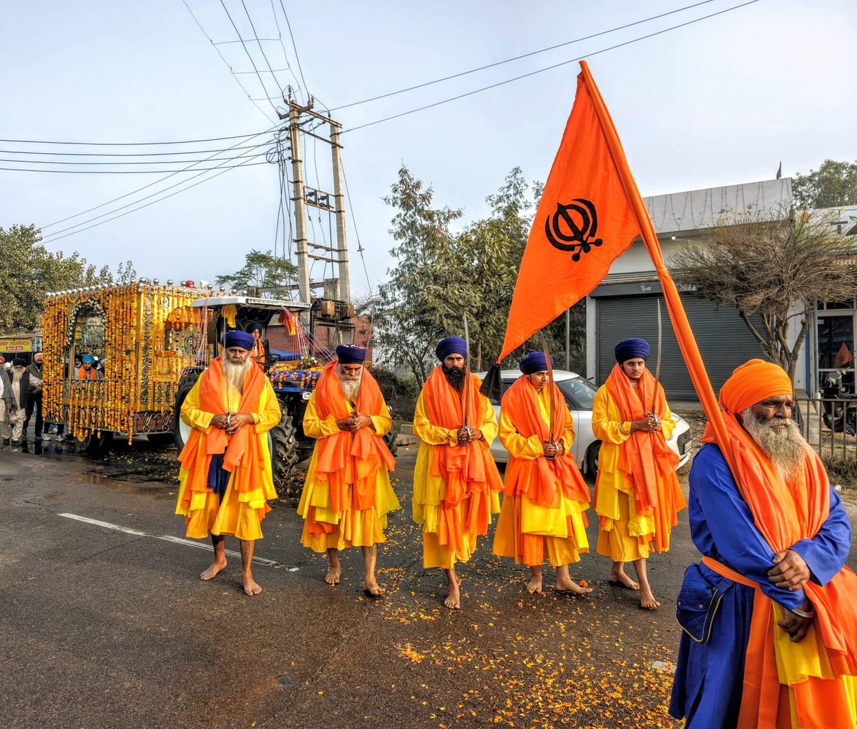 Devotees bowed down at the feet of Guru Sahib in Nagar Kirtan