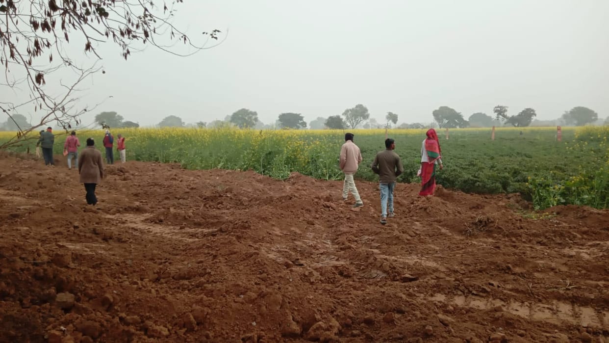 The contractor dug up the field and laid the pipeline.