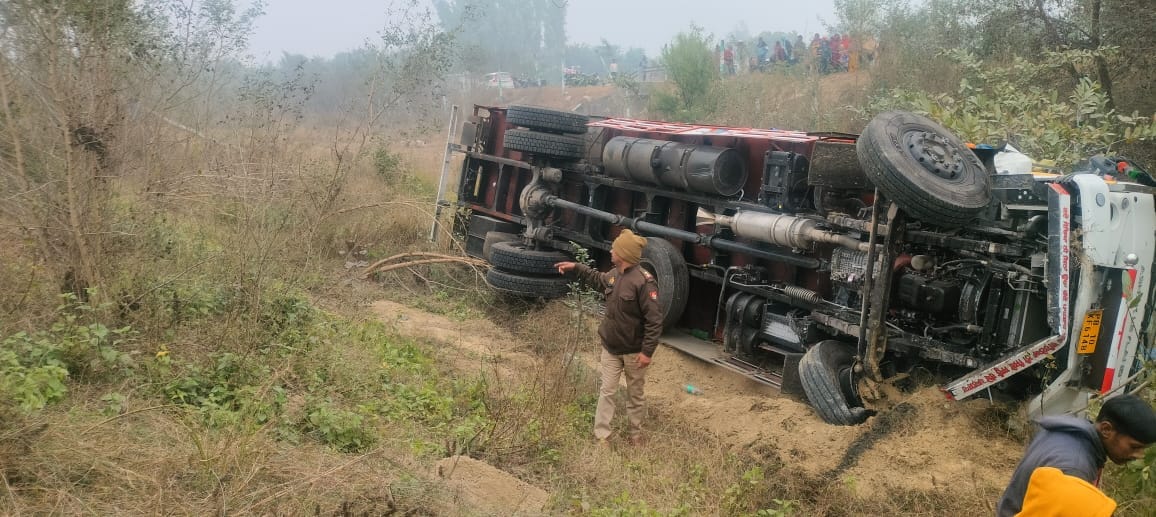 A truck overturned into a 15-foot-deep ditch after a tyre burst on the Purvanchal Expressway, injuring the driver.