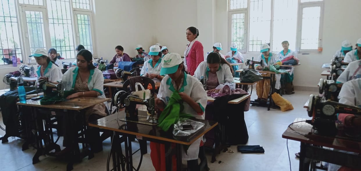 Women taking training in tailoring and mushroom production