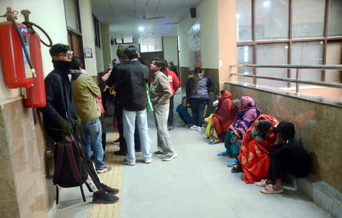 People are forced to sit on the floor in the bitter cold.