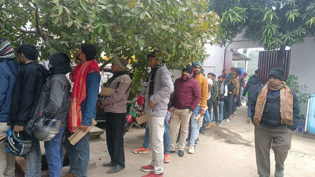 Applicants line up at the gate to get their driving licenses.