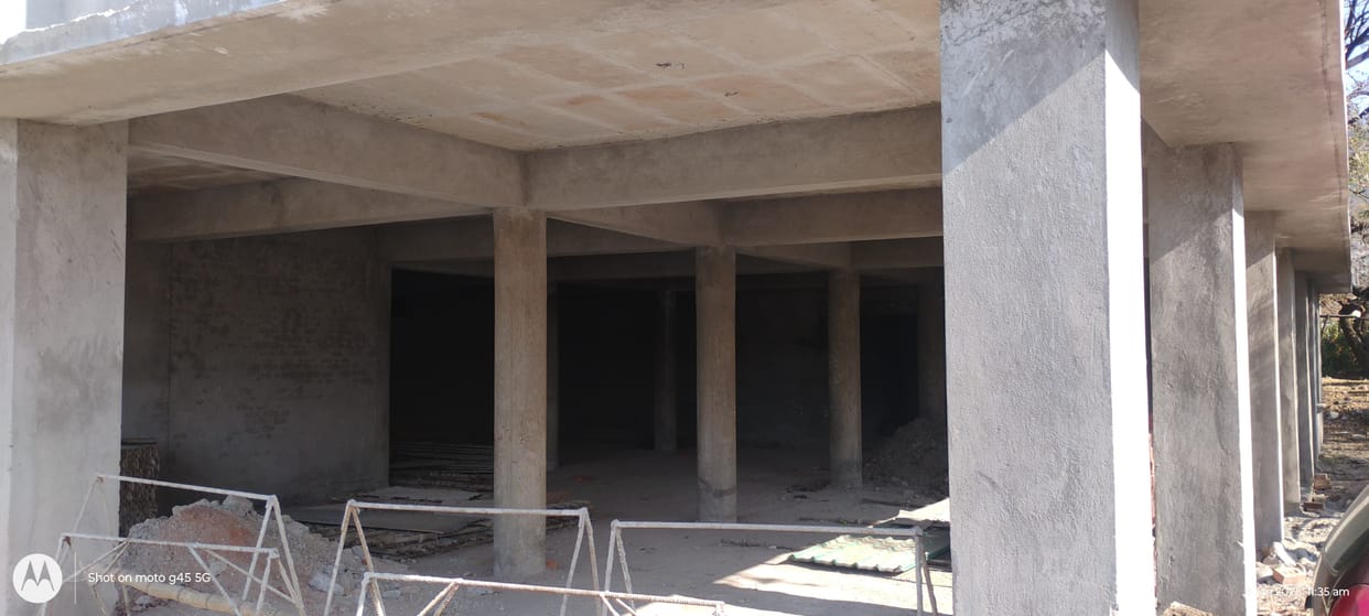 The Town Hall remains in limbo, with an incomplete roof, open skylights, and dilapidated cement walls.
