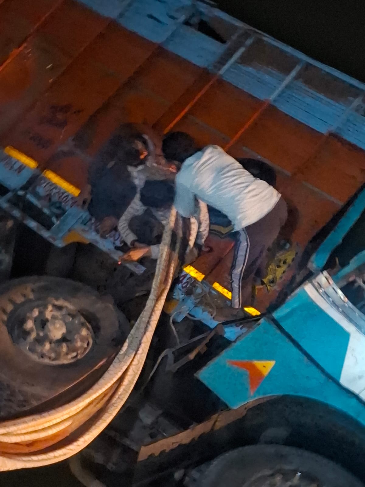 A truck loaded with sand fell into a canal while trying to save a biker.