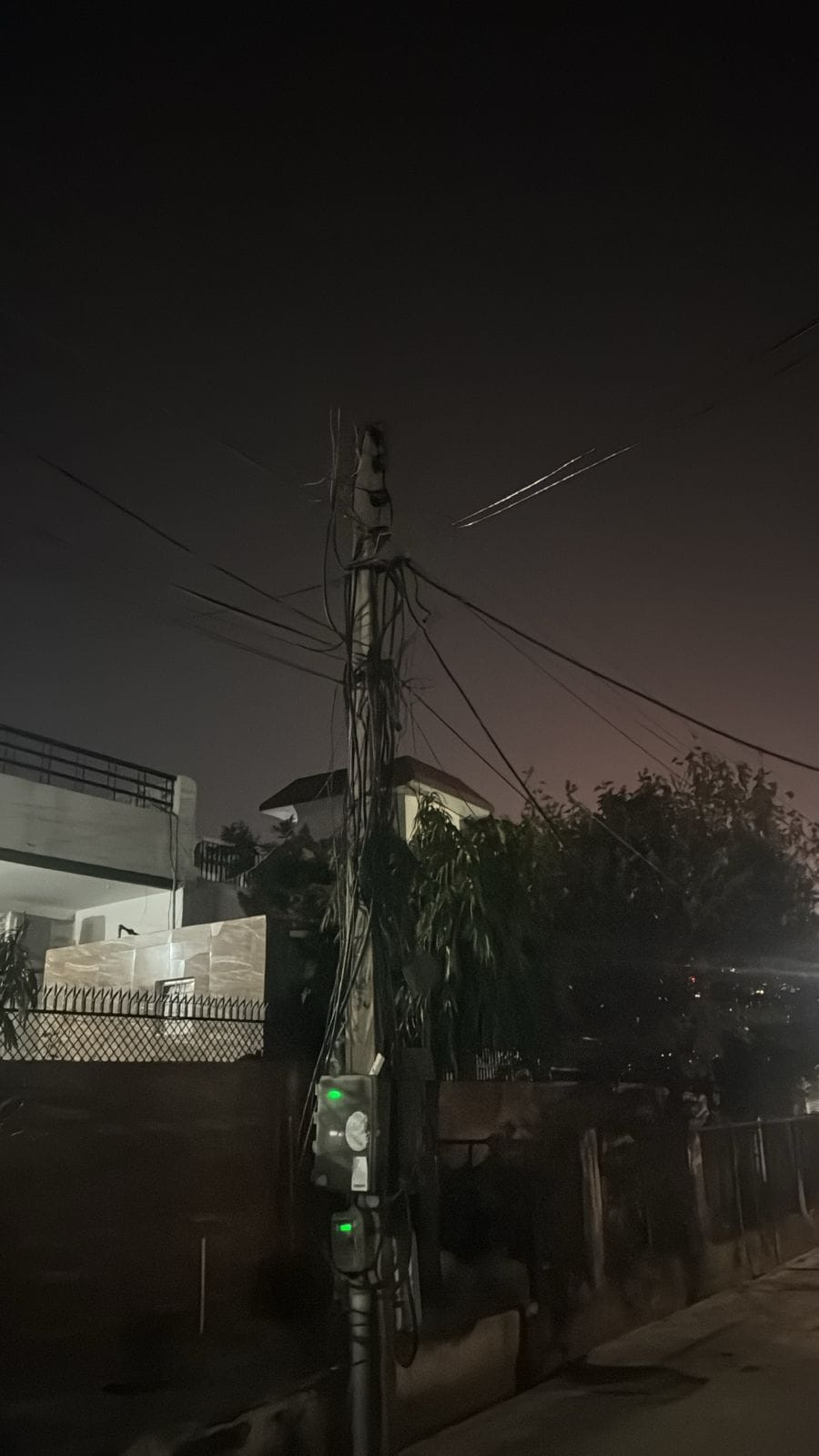 A network of electrical wires and cables stretched across the poles.
