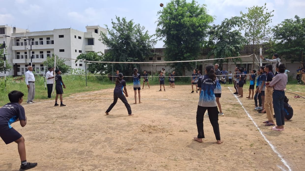 45 volleyball players are practicing at Kasturba Gandhi School.