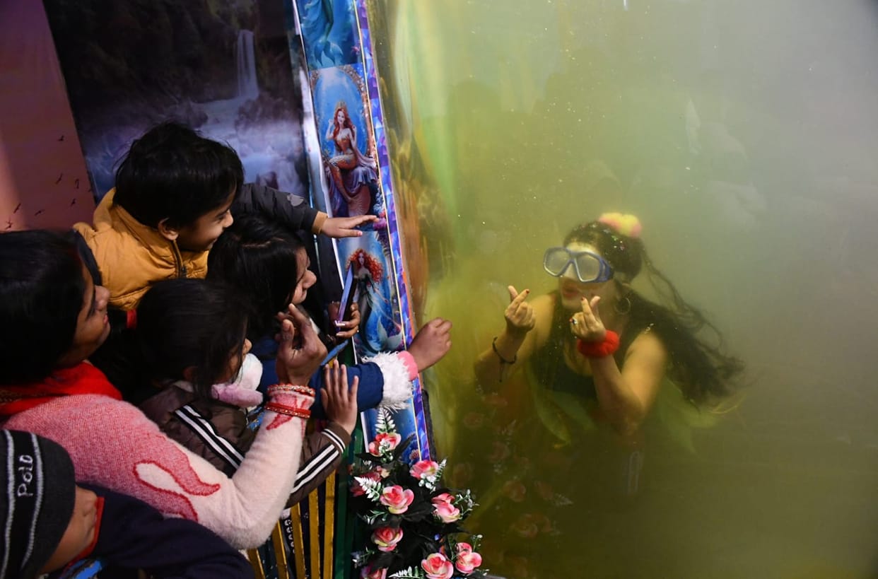 A mermaid arrives for the first time at the Gorakhnath fair, attracting children in Gorakhpur