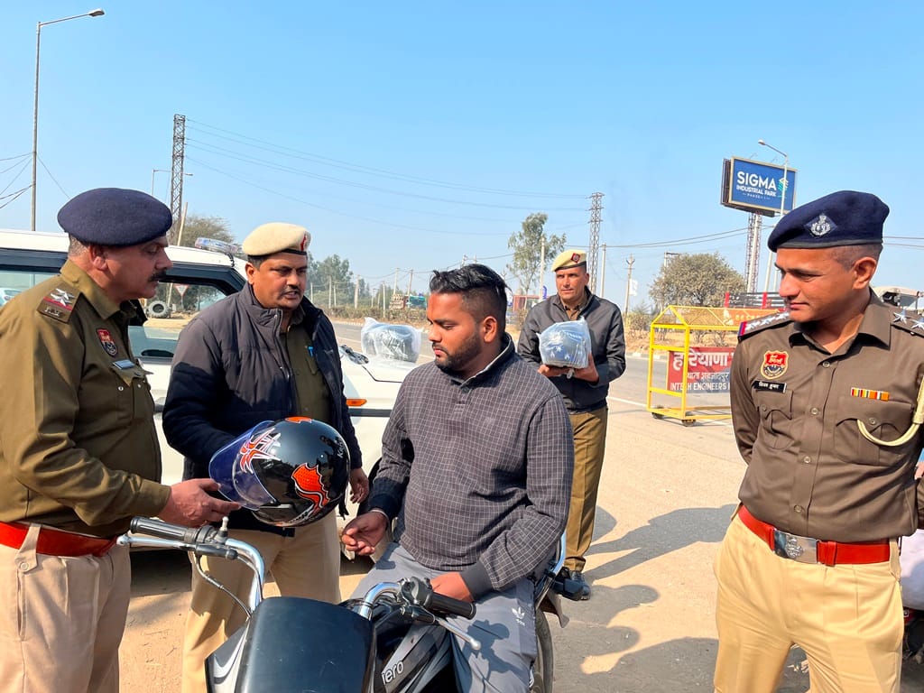 Helmets were distributed to drivers without helmets.