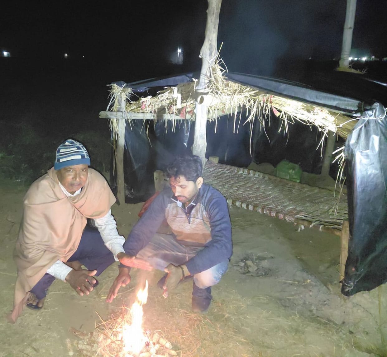 With a flashlight in one hand and a stick in the other, they brave the cold to protect their crops, risking their lives.