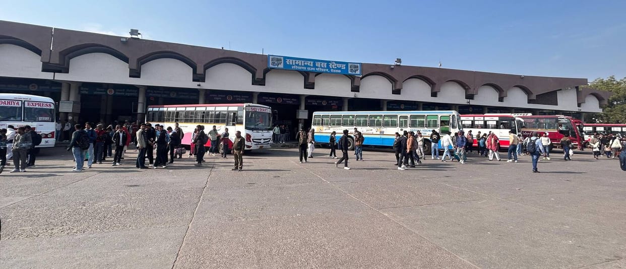 Private buses dominate the bus stand, roadways are less due to lack of staff.