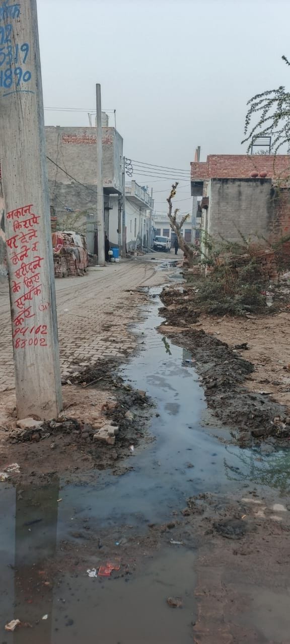 Sewage water has accumulated in the street, causing problems.