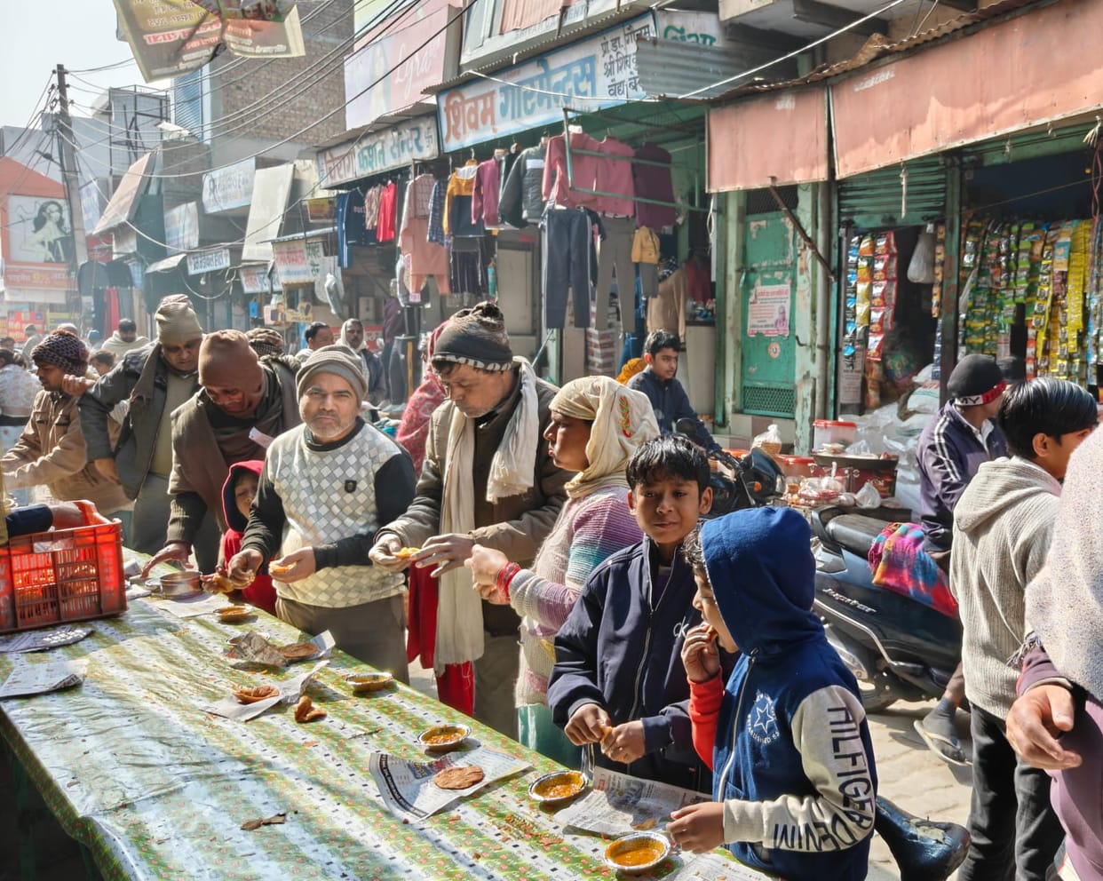 People received puri and vegetable curry as prasad (blessed food) at the community feast.