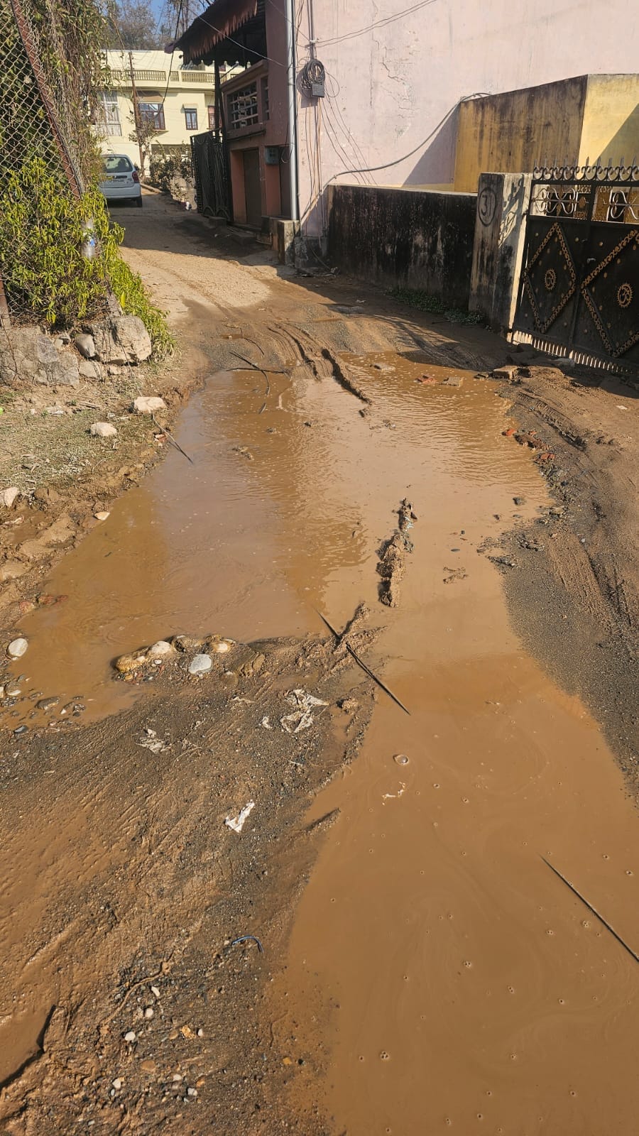 The road to the Housing Board Colony in Nurpur is in a dilapidated condition, causing problems for the people.