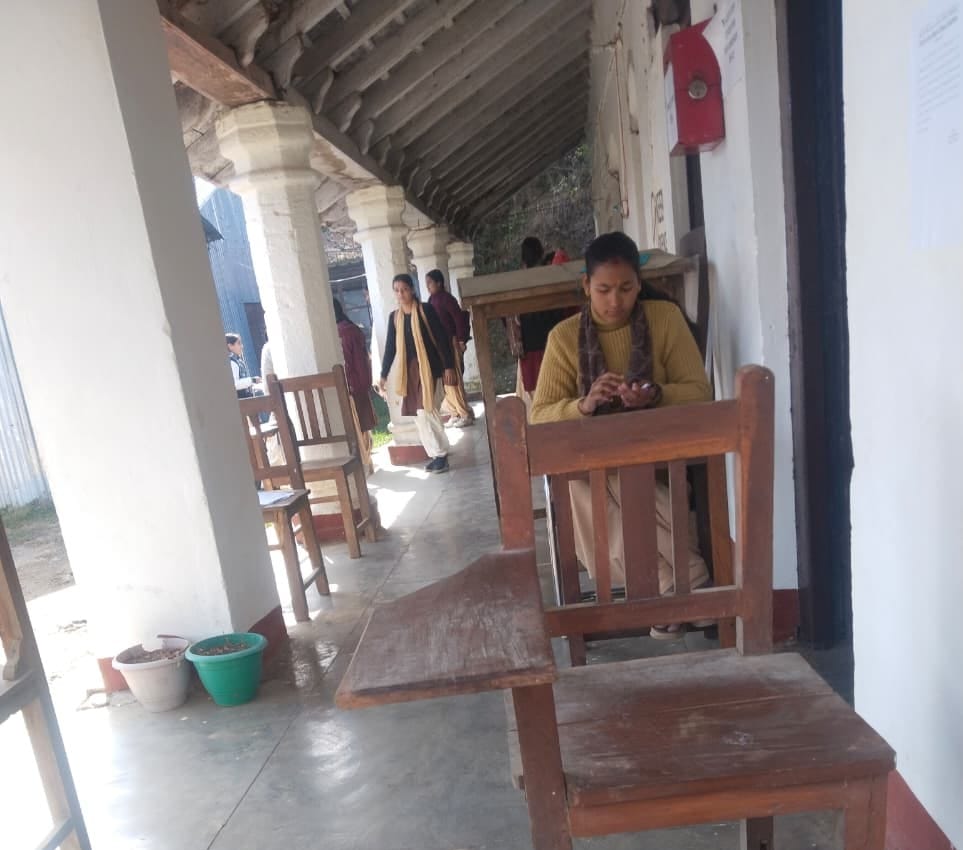 Students at Gangolihat College take exams in the veranda in the bitter cold.