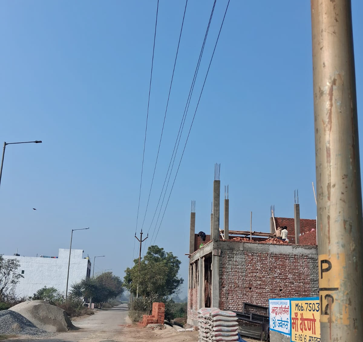 Negligence: Buildings started being constructed on the allotted plot, high tension line was not removed.