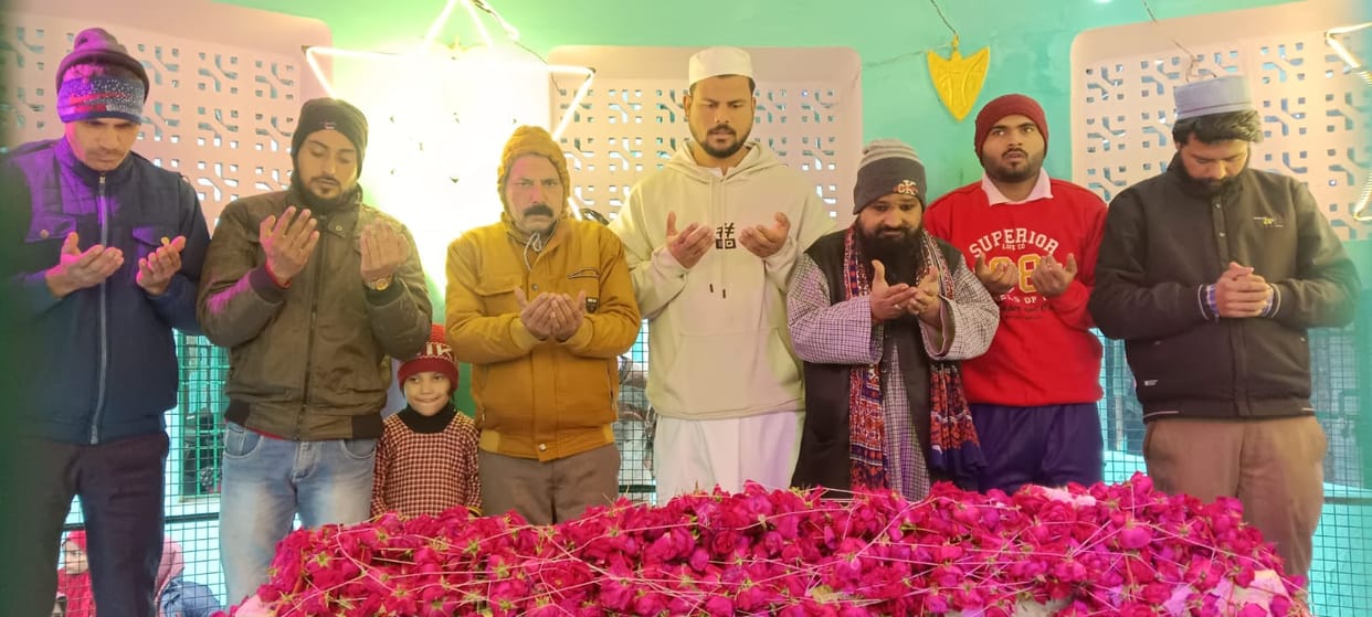 Floral offerings and a ceremonial cloth were placed at the shrine of Nemat Shah Wali.