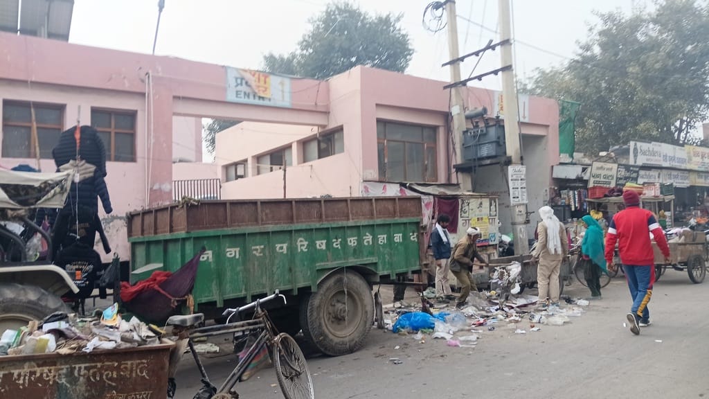 The city's sanitation system is in disarray, with garbage scattered throughout the markets until midday