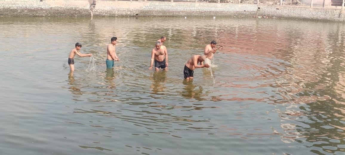 On the new moon day, devotees took a dip in the lake.