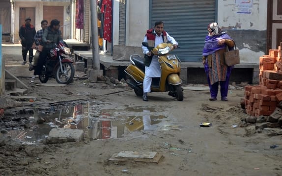 Pits have been dug and left open...water is accumulating in front of the shops, causing traffic jams.
