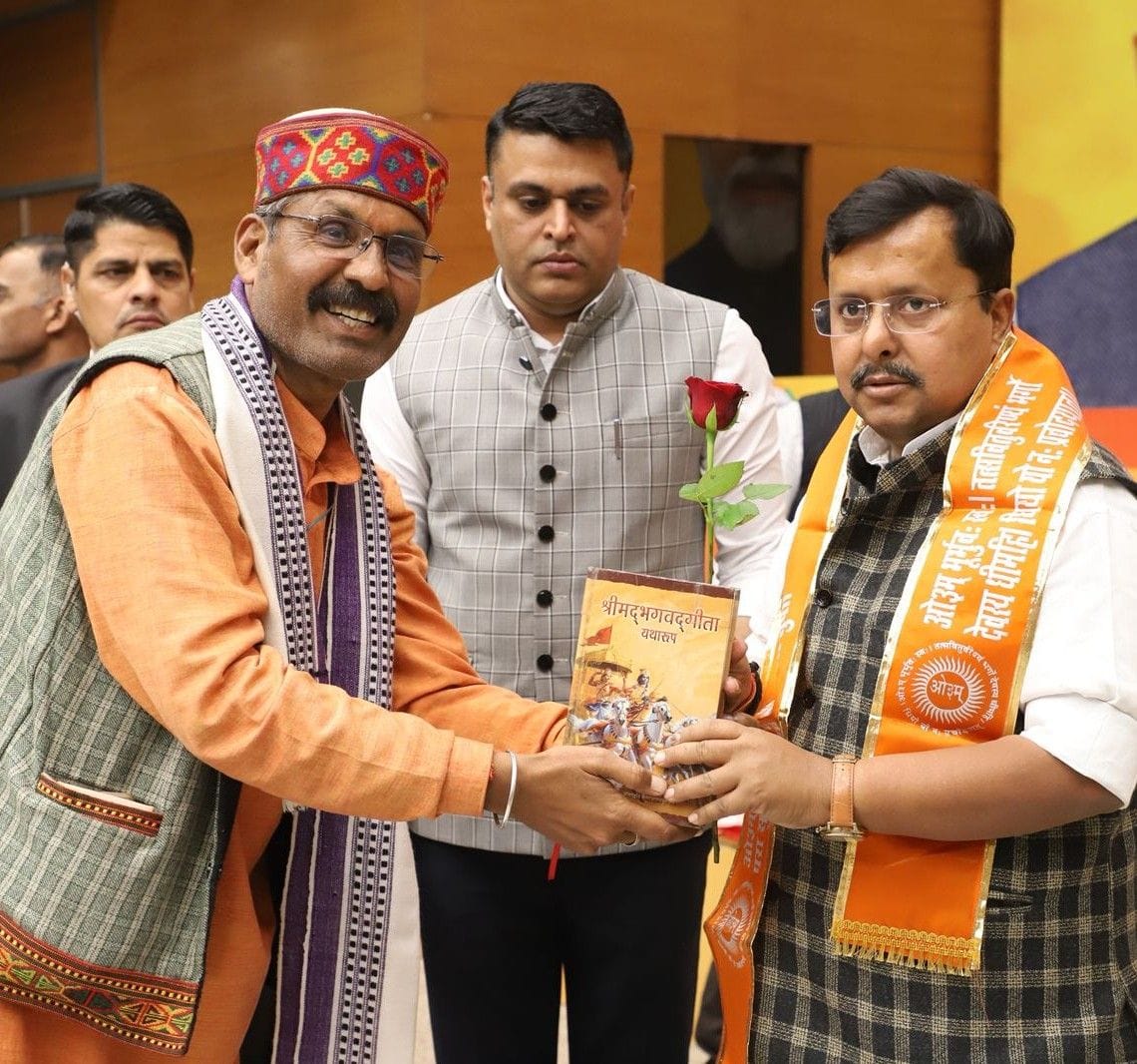 Presenting Geeta Granth to Nitin Navin and demanding allocation of a seat