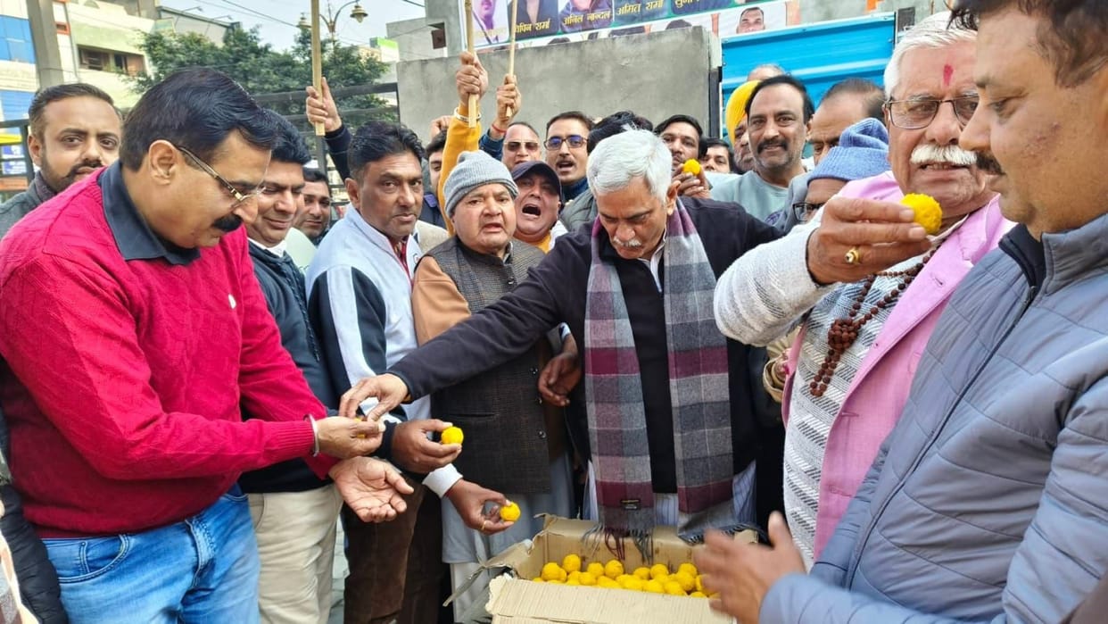 Workers distributed laddus in honor of the BJP National President.