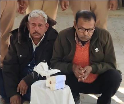 Two arrested for selling liquor at inflated prices before the scheduled time.