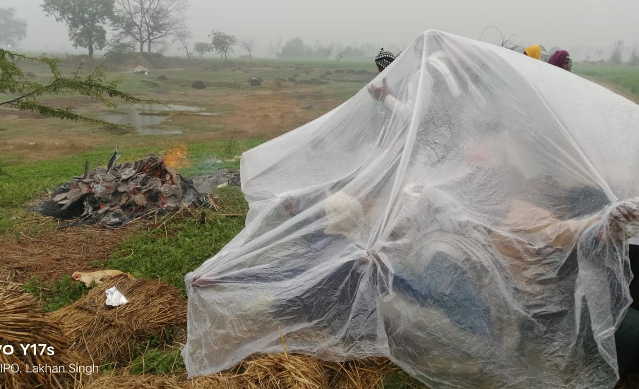 The last rites were performed sitting under a tarpaulin