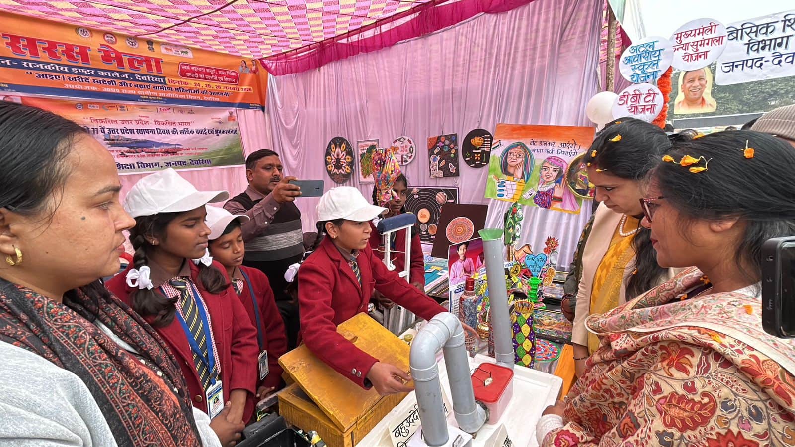 उत्तर प्रदेश स्थापना दिवस पर उच्च प्राथमिक विद्यालय सहवां के स्टॉल का निरीक्षण करते अधिकारी, फ