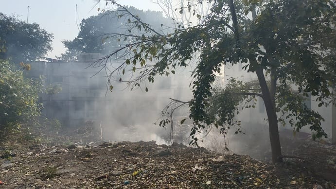 Someone set fire to the garbage next to the police station, and passersby were left coughing.