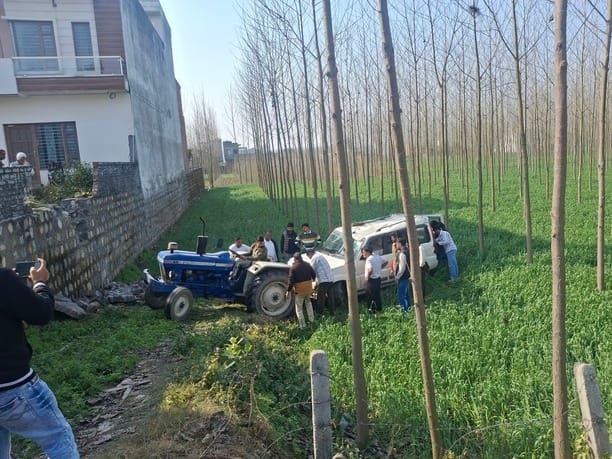 The out-of-control car crashed through a wall and landed in a wheat field