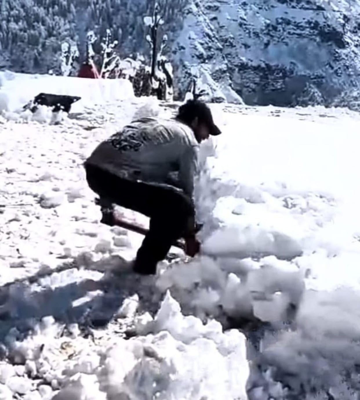 Villagers busy removing snow from rooftops with shovels
