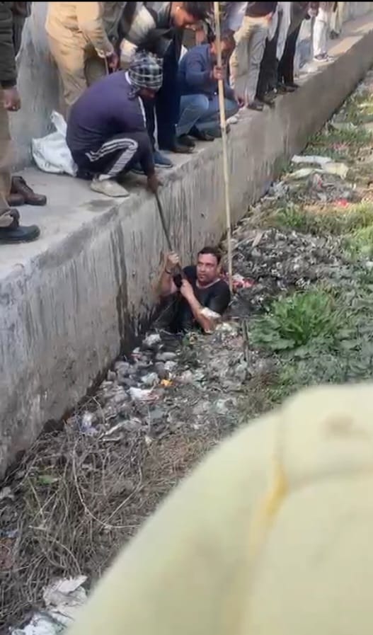A teenager is suspected to have fallen into a drain...the police officer waded 6 feet into the water to search for him.