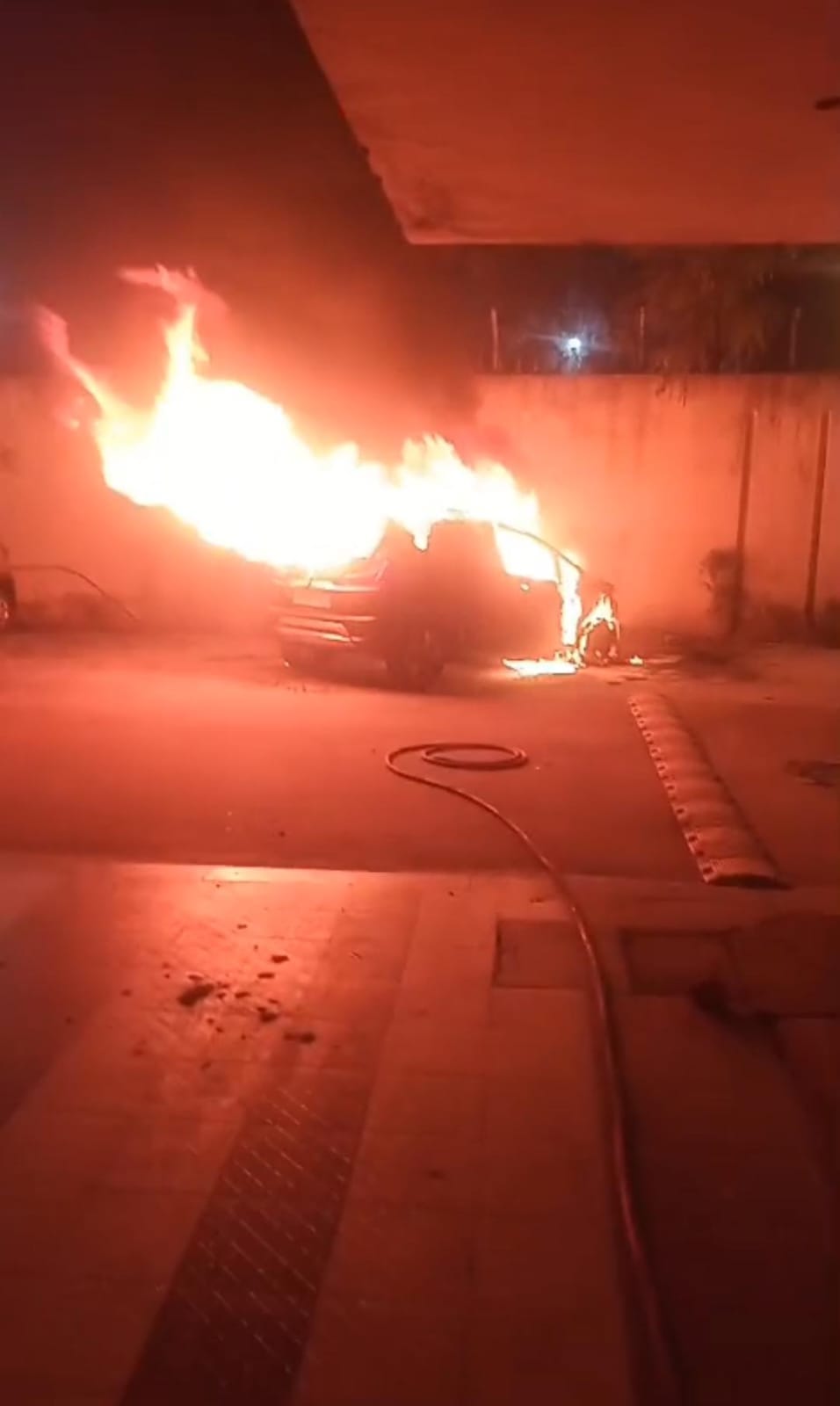 A car parked in an apartment parking lot caught fire