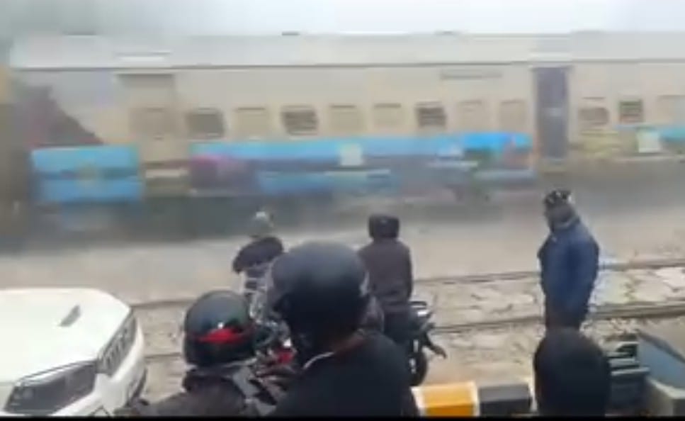 A train rumbled past as a bike and car were stranded after a railway crossing gate suddenly closed.