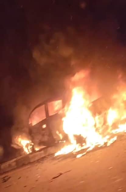 The car, which went out of control and hit the divider, caught fire.