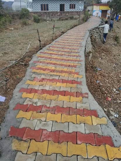 Village walkways being constructed using interlock tiles